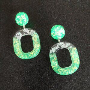 Neon green glow oval shaped dangle earrings with silver foil iridescent glitter